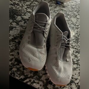 On cloud gray sneakers.